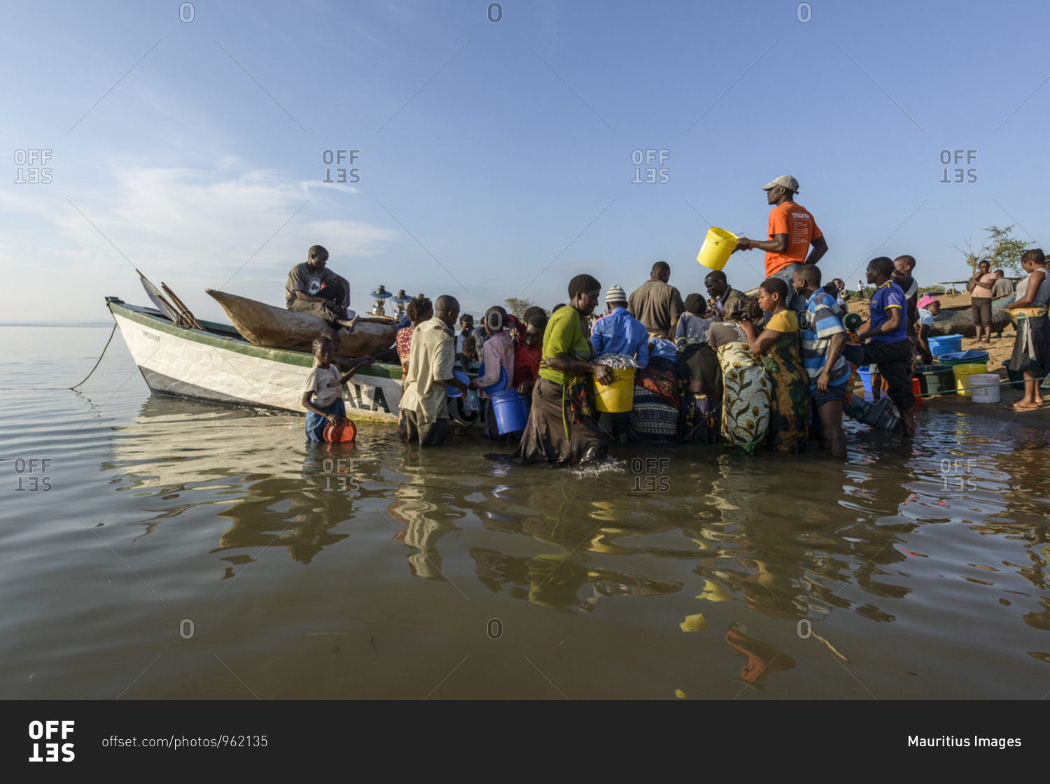 November 21, 2014: People on fish market on Lake Malawi,\
Malawi, Africa People on open-air fish market at Lake Malawi,\
Malawi, Africa stock photo - OFFSET
