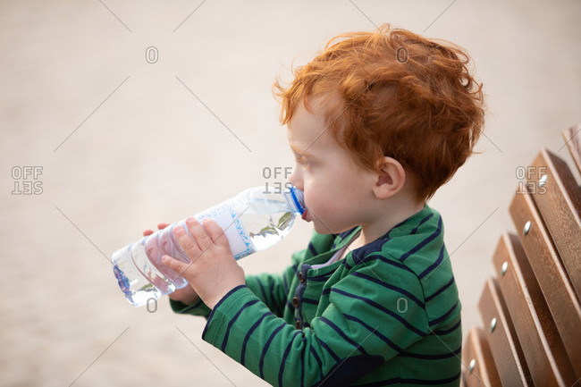 Teen Boy Holding Water Bottle High-Res Stock Photo - Getty Images
