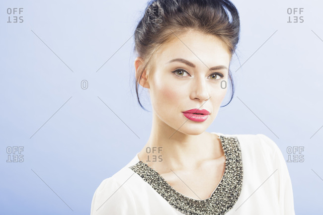 Beautiful young woman looking at camera, studio portrait