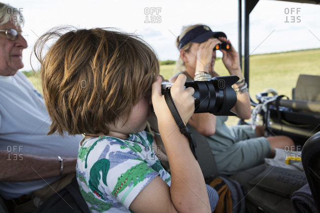 Five year old boy photographing, Moremi Reserve, Botswana