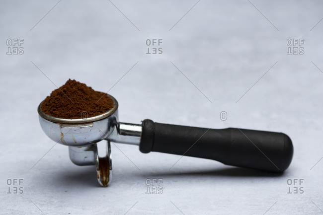 barista holding tamper above portafilter with grinded coffee, espresso, manual  press, arabica Stock Photo by LightFieldStudios