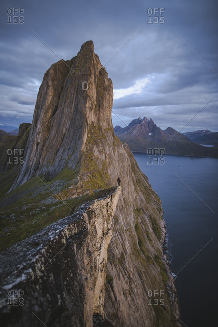 Norway, Senja, Man standing on cliff edge near�Segla�mountain