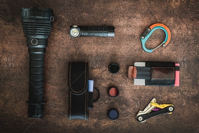 An amount of some EDC (Everyday carry) items on a wooden surface.