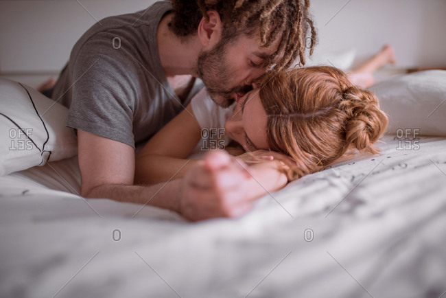 Romantic Black Couple Hugging while Sleeping in Bed Stock Photo