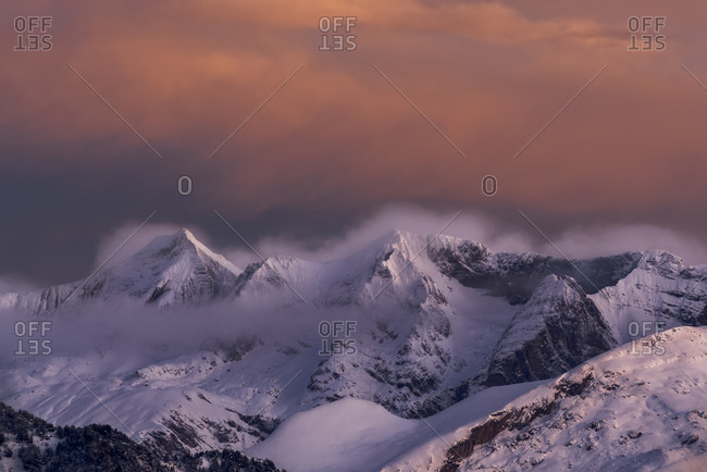 Magnificent view of mountains covered with snow at sunset