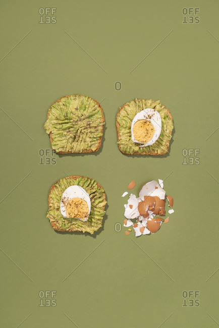 Top view of avocado toasts with boiled eggs for breakfast