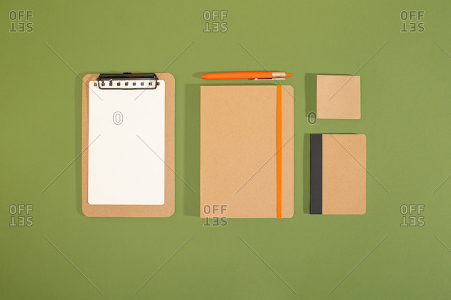 Bunch of recycled office supplies from above with green background