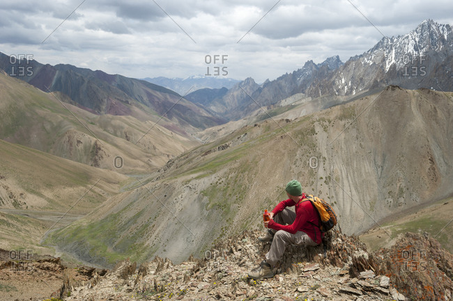 A trekker stops to admire the views from the top of the Konze La in the remote Himalayan region of Ladakh in northern India