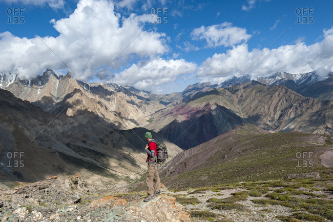 A trekker takes in the dramatic scenery from the top of the Dung Dung La on during the Hidden valleys trek