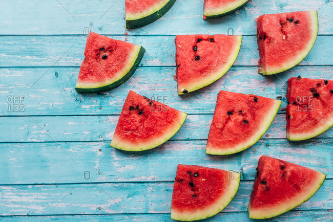 Triangular slices of watermelon on a blue background