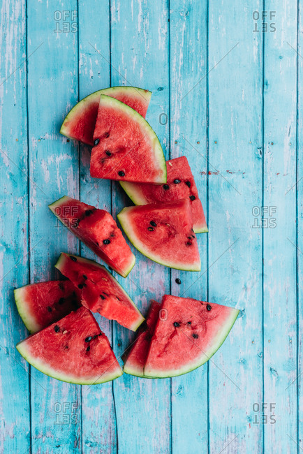 Sliced watermelon triangles on a blue background