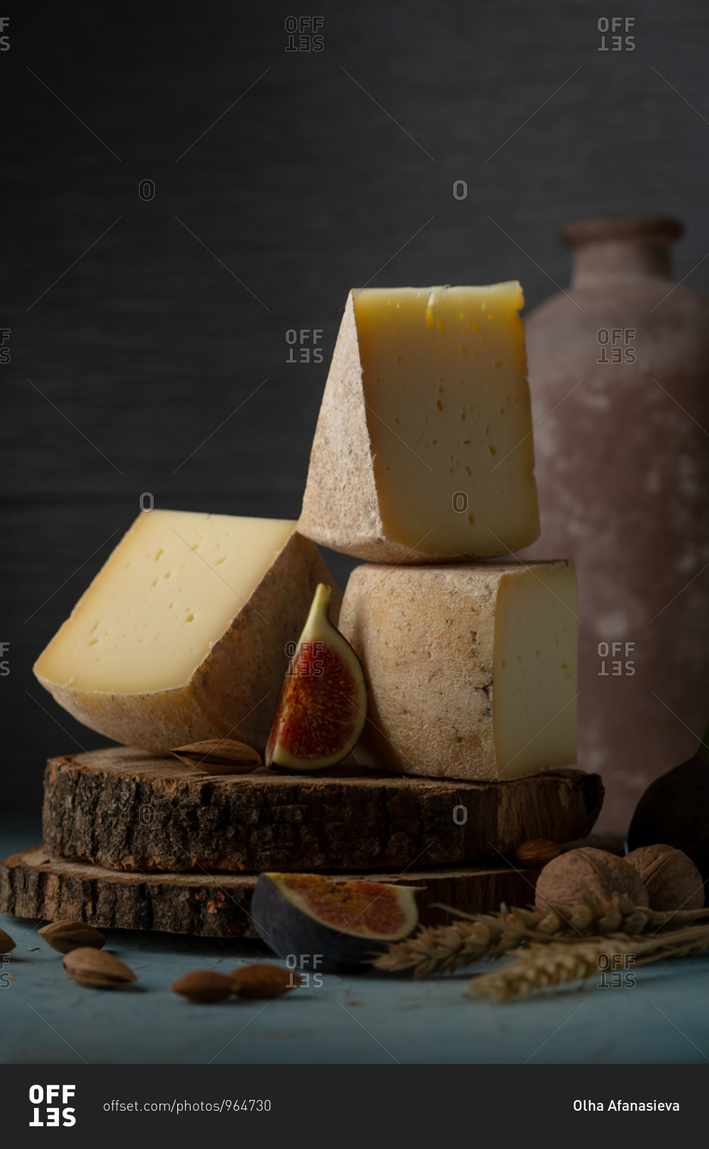 Homemade swiss cheese on old wooden disks with figs