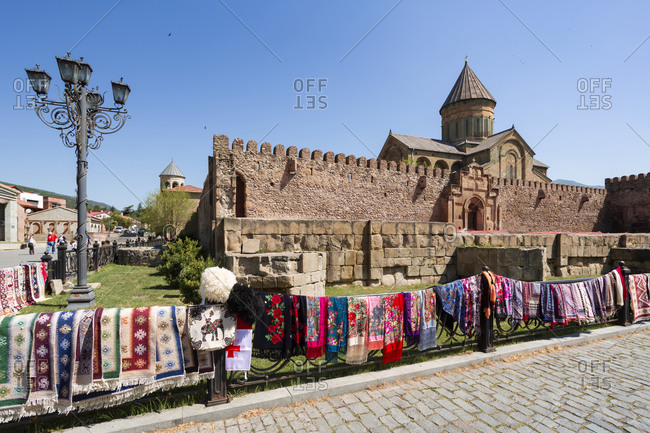 Georgia- Mtskheta-Mtianeti- Mtskheta- Colorful rugs being sold in front of Samtavro Monastery