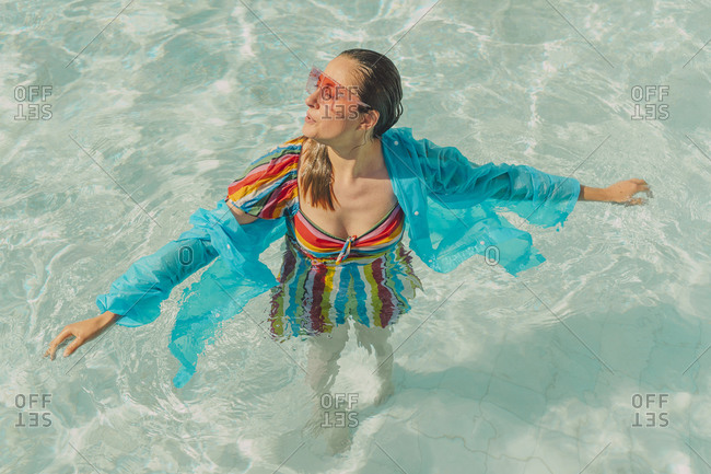 Dressed woman relaxing in swimming pool