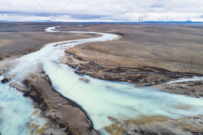 Aerial view of wide and winding river through the desolate and uninhabited Sprengisandur area in the highlands of Iceland