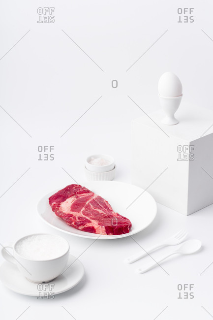 Still life with white dishware and beef steak