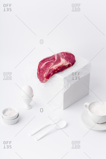 Still life with white dishware and beef steak
