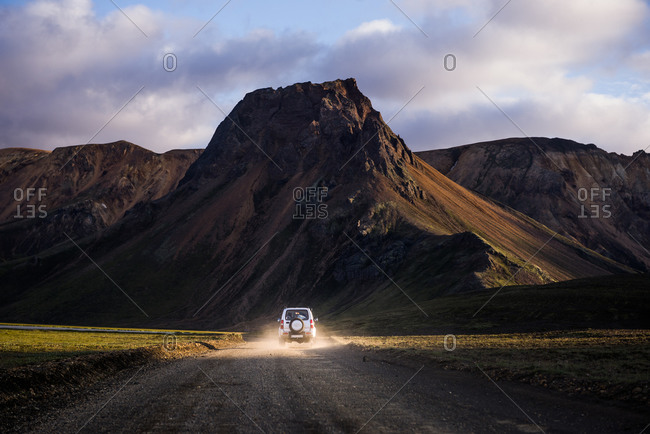 Off road vehicle driving towards mountain ranges, Landmannalaugar, Highlands, Iceland