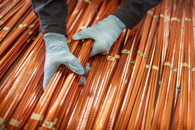 Close up of electrical engineer inspecting copper windings in electrical engineering factory