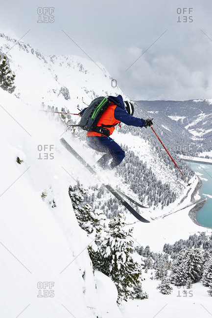 Skier skiing off slope, Kuhtai, Austria