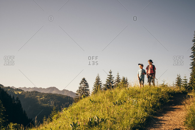 Boys enjoying view on hilltop, Bludenz, Vorarlberg, Austria