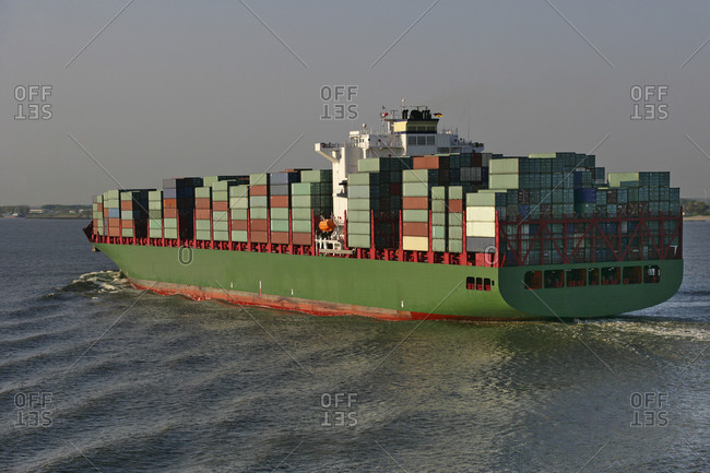Elbe River near Glucksburg, Schleswig-Holstein, Germany - April 25, 2009: Freight container ship in the Elbe river near Hamburg, Germany.