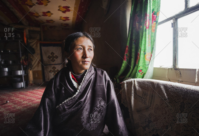 A young Tibetan woman in her traditional house, Tibetan plateau