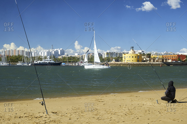 October 28, 2018: View from Ferragudo with anglers to the marina of Portimao, Ferragudo, Faro, Algarve, Portugal