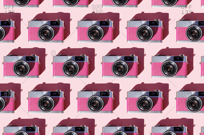 Seamless pattern of rows of vintage analog cameras