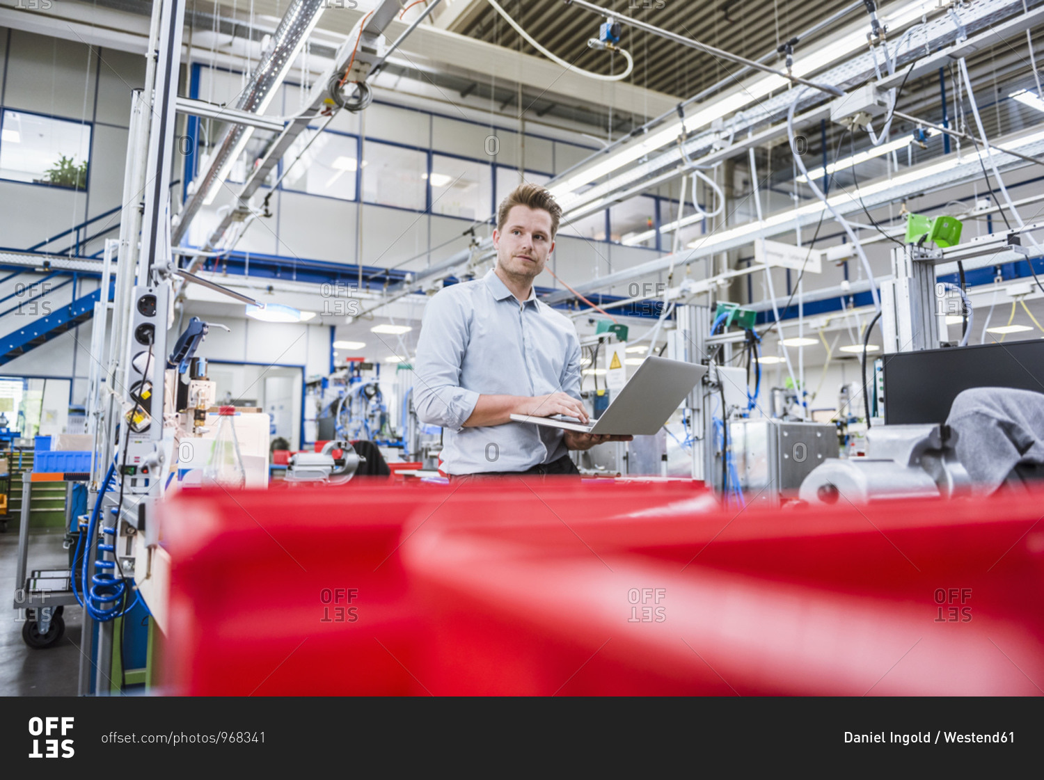 Man using laptop in factory