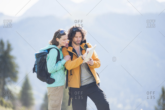 Hiking couple looking at map- Wallberg- Bavaria- Germany