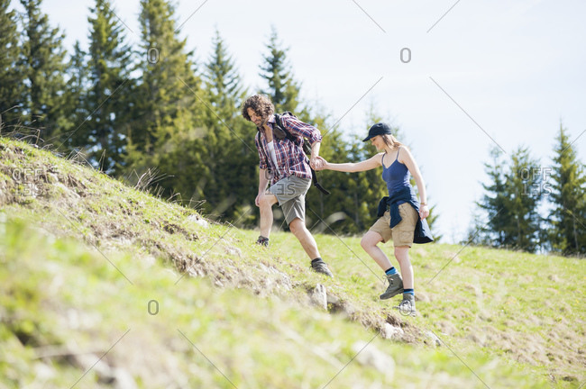 Hiking couple on meadow in summer- Wallberg- Bavaria- Germany