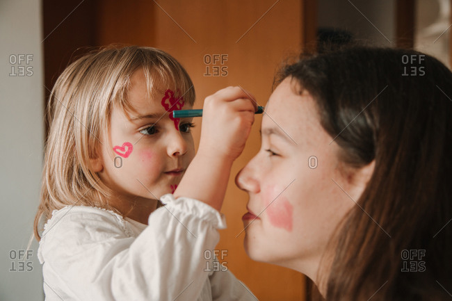 Boy with red and black face paint stock photo - OFFSET