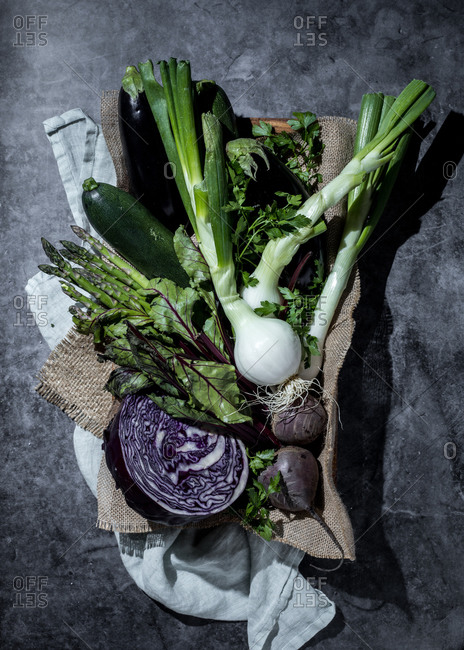 Green asparagus bunch on wicker tray on white table background