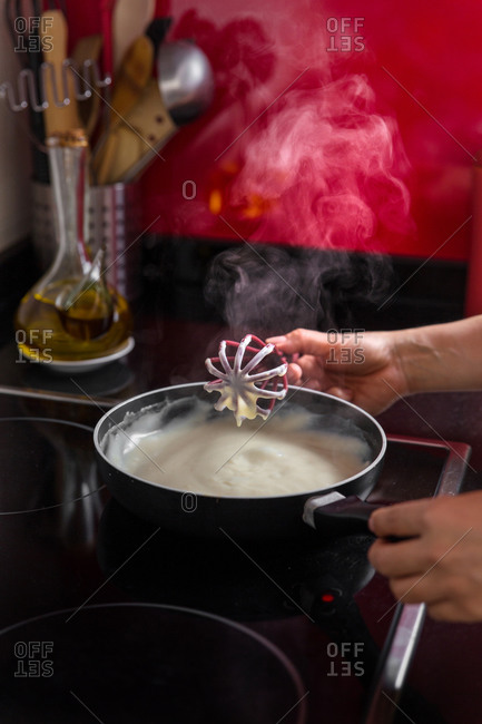 Woman stirring cream mixture in a pan