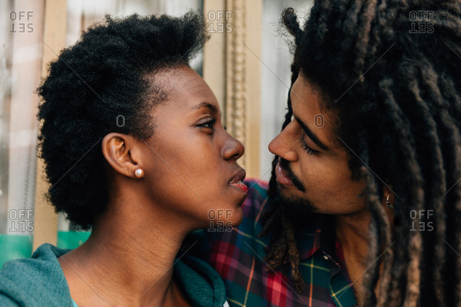 Mixed race couple kissing outside