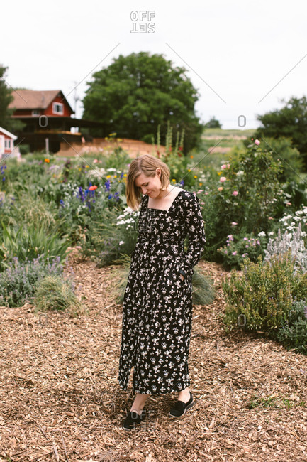 Woman in a floral dress in her flower garden