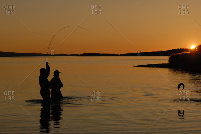 man and woman fishing silhouettes