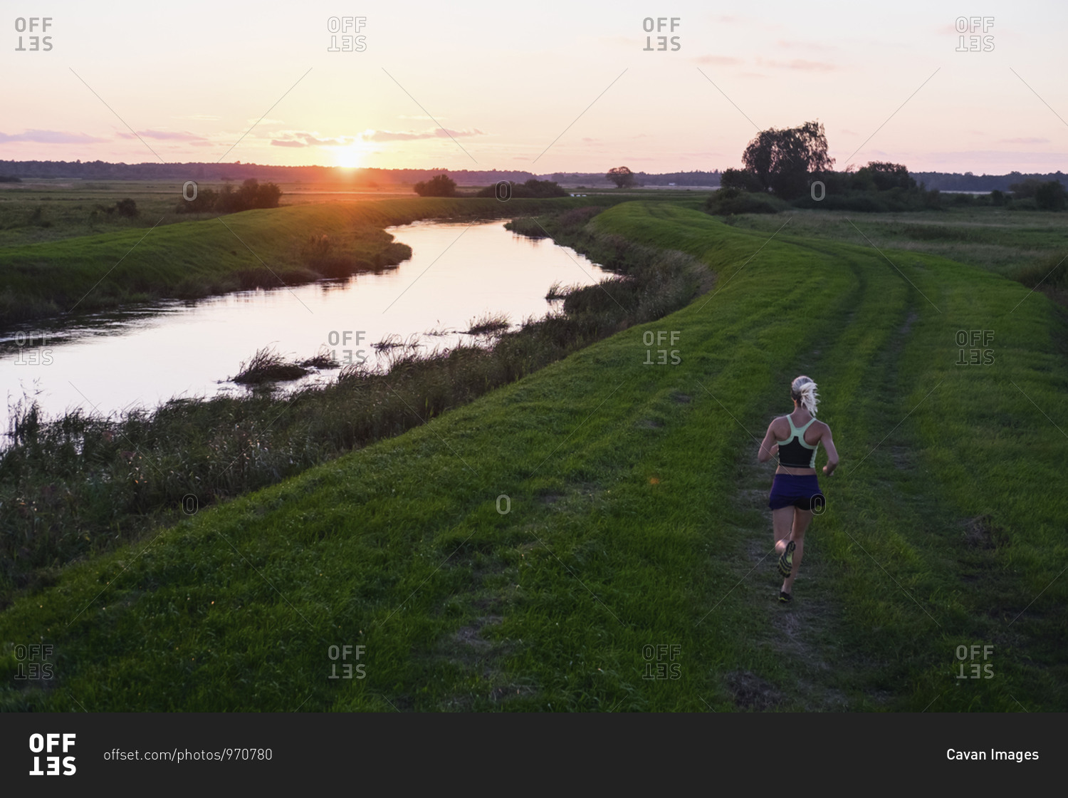 Woman trail running along Leba River, Pomerania Province, Poland