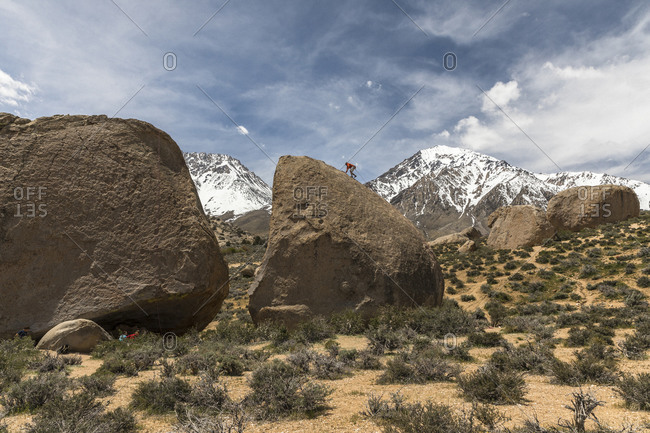 Rock climber climbing rock formation, Bishop, California, USA