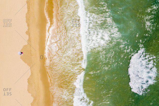Woman sunbathing on sandy coastal beach, Sunshine Beach, Queensland, Australia