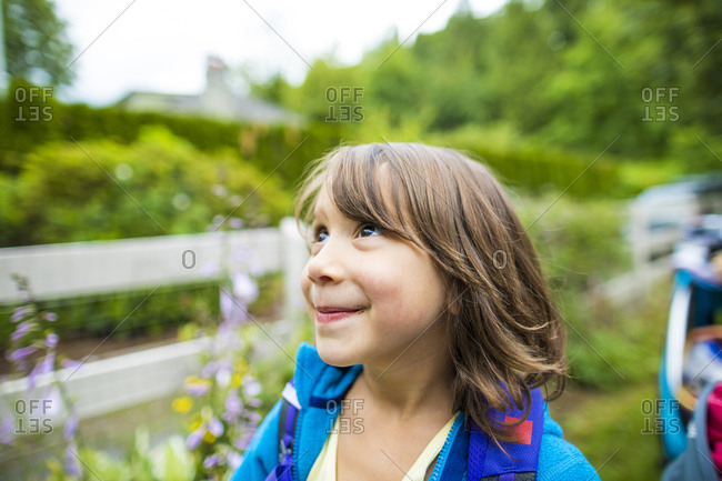 Portrait of little girl looking up outdoors, Chilliwack, British Columbia, Canada