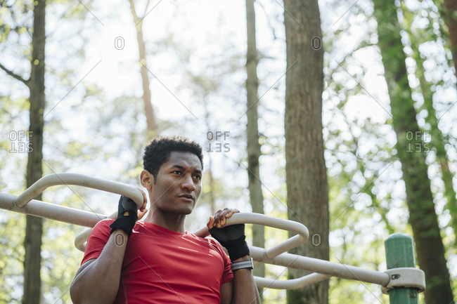 Young girl hanging upside down exposing underwear on climbing