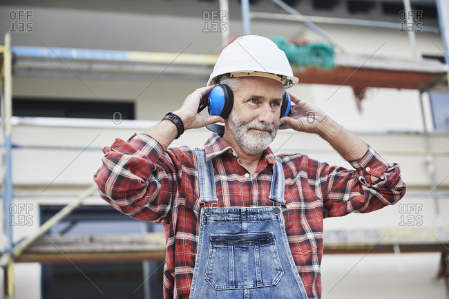 Construction worker with ear muff working at construction site