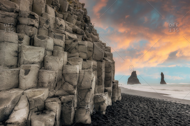Famous basalt columns at Reynisfjara beach with iconic Dyrholaey sea stacks, Southern Iceland