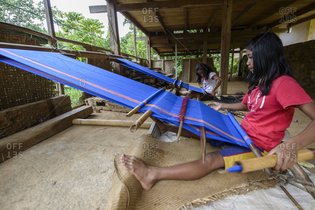 April 9, 2013: Girls weave textiles, Tana Toraja, Sulawesi, Indonesia