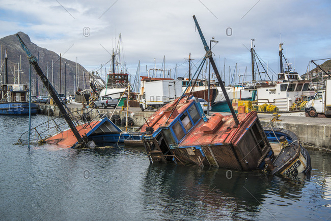 March 5, 2017: Sunk fishing boat in Kalk Bay harbor, False Bay, South Africa