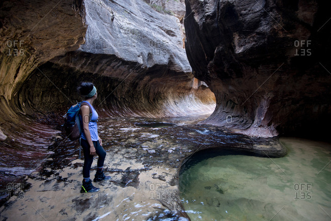 Young woman hiking through tunnel, Zion National Park, Utah, USA