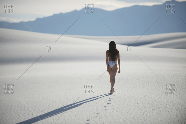 Woman walking in desert, White Sands National Monument, New Mexico, USA