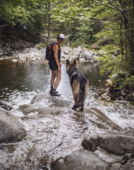 Female hiker with dog, White Mountains, New Hampshire, USA